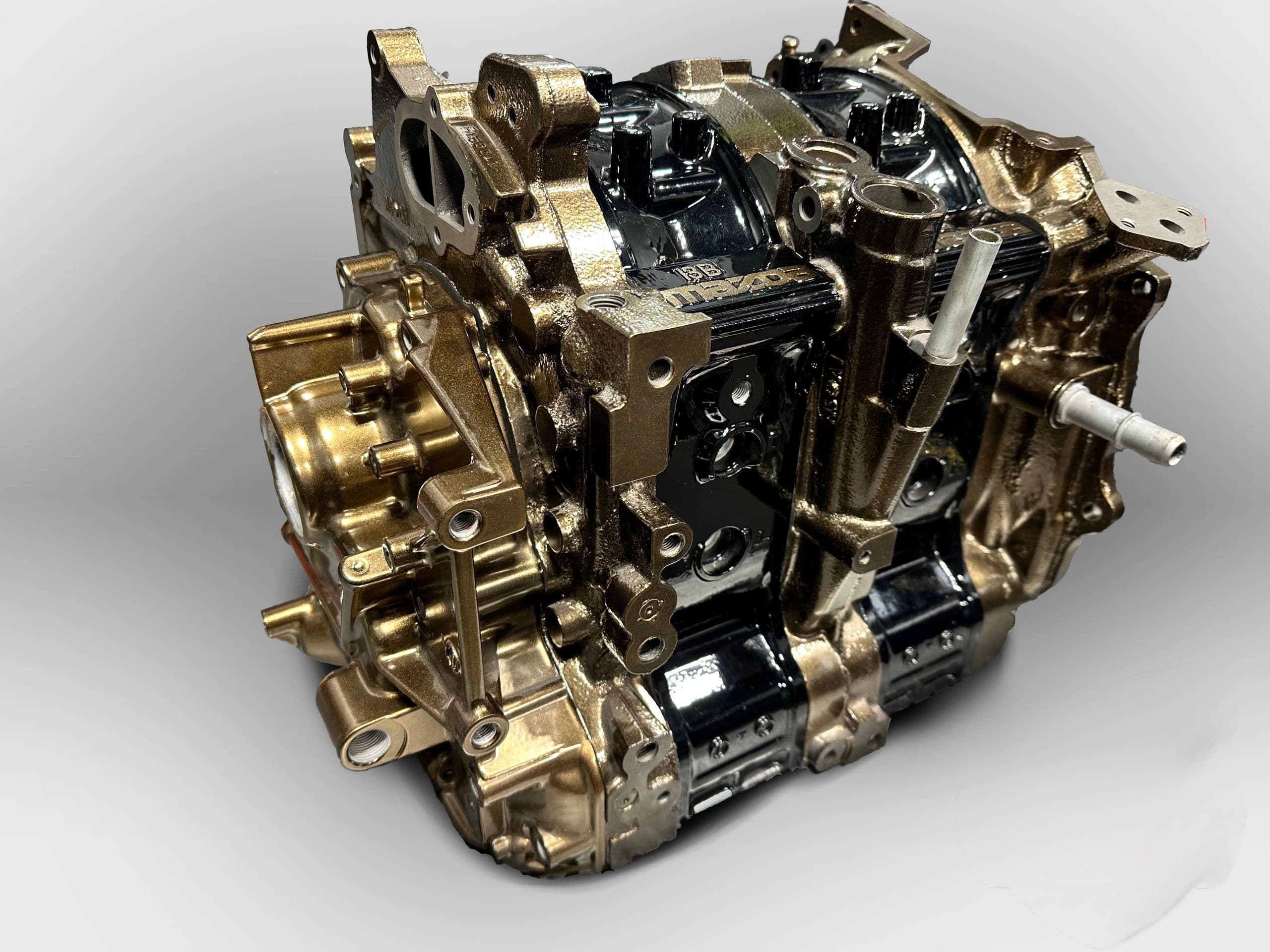 Assembled Mazda 13B rotary short block with gold-coated rotor housings